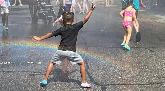 A child dancing in the water spray