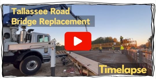 Large boom truck next to a bridge under construction