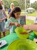 A 2022 Athens Water Festival attendee at an activity booth.