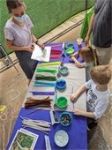 Children making riparian buffer bracelets at the Athens Farmer's Market.