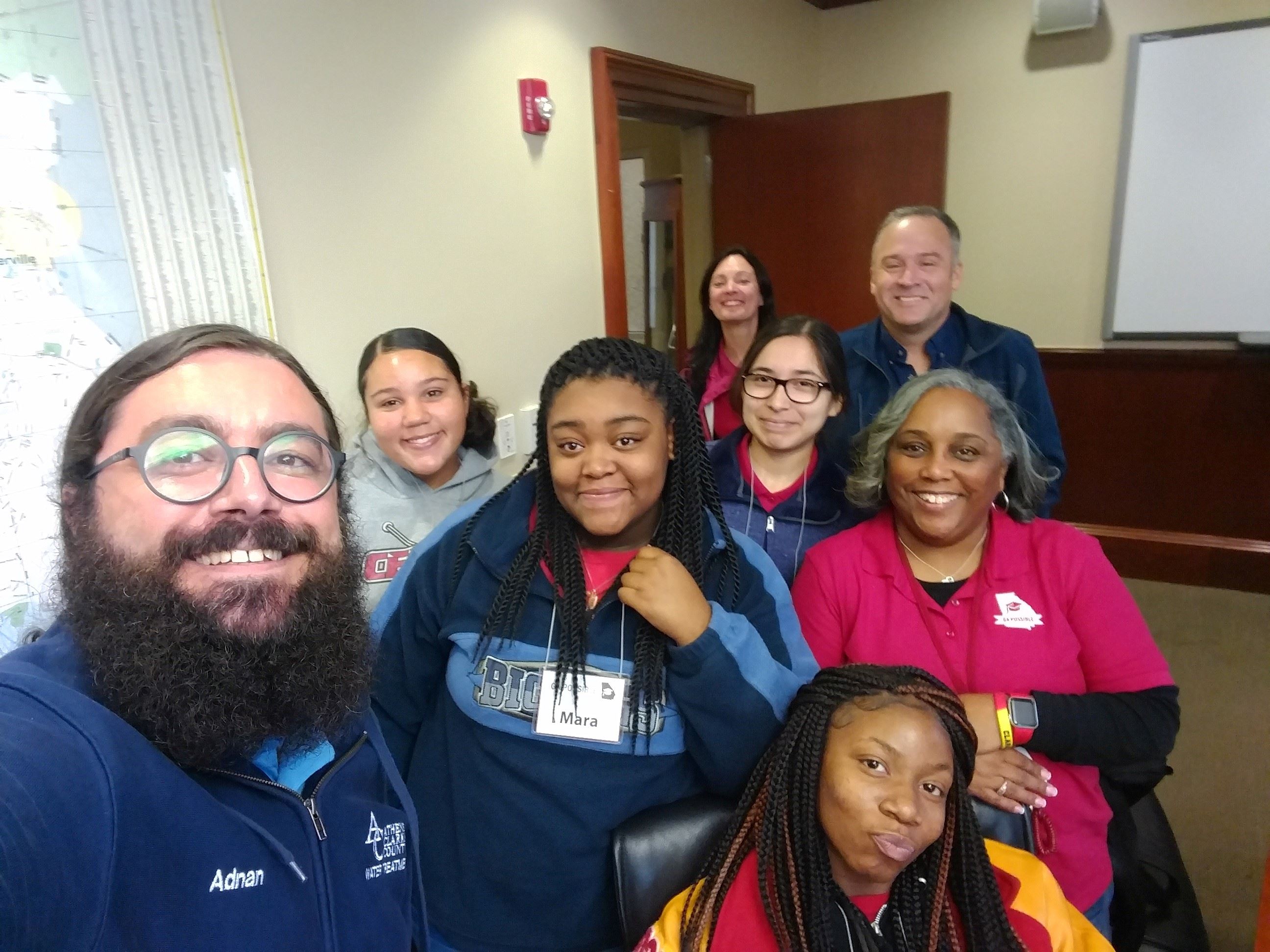 Adnan Aydin and Will Cottrell take a selfie with students from GA Possible
